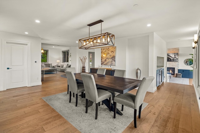 1157 Glenview Rd, Montecito, CA 93108 - dining room with a large fireplace, light wood finished floors, recessed lighting, and a chandelier