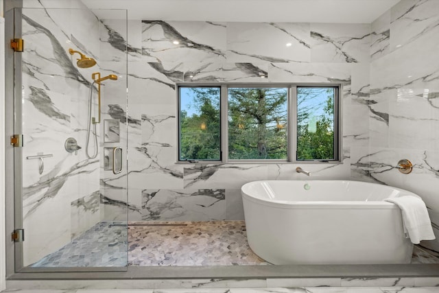 1157 Glenview Rd, Montecito, CA 93108 - bathroom featuring a soaking tub, a marble finish shower, tile walls, marble finish flooring, and stone wall