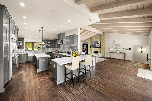 1151 Glenview Rd, Montecito, CA 93108 - kitchen with wall chimney range hood, gray cabinets, a center island, decorative backsplash, and recessed lighting