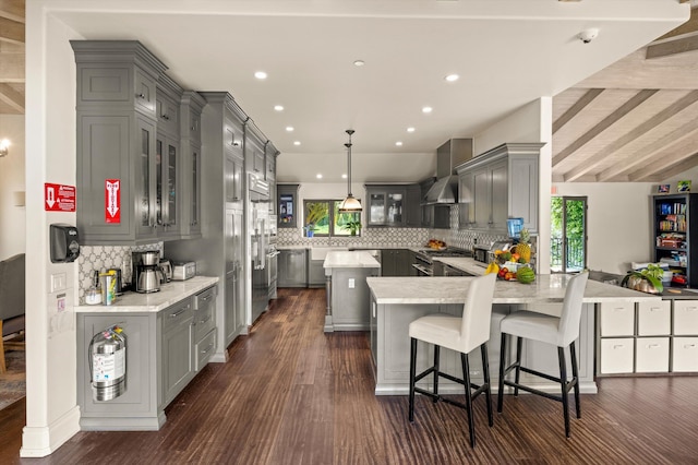 1151 Glenview Rd, Montecito, CA 93108 - kitchen featuring gray cabinets, wall chimney range hood, a peninsula, backsplash, and recessed lighting