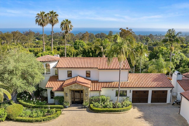 1151 Glenview Rd, Montecito, CA 93108 - mediterranean / spanish home featuring a tile roof, french doors, a garage, stucco siding, and decorative driveway