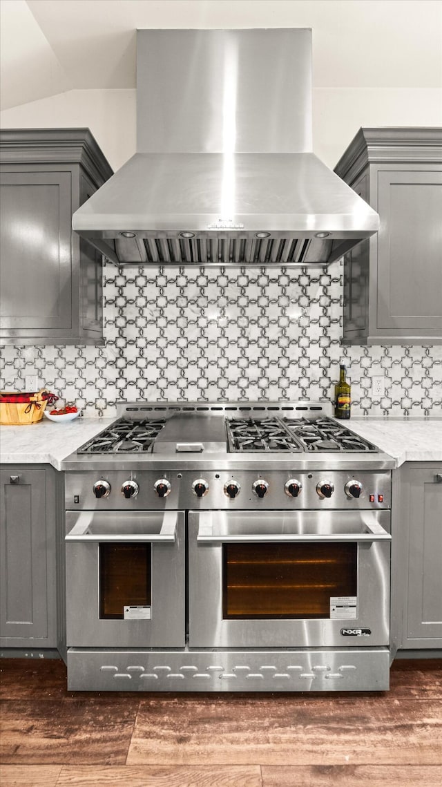 1151 Glenview Rd, Montecito, CA 93108 - kitchen featuring wall chimney range hood, double oven range, gray cabinets, tasteful backsplash, and dark wood-type flooring