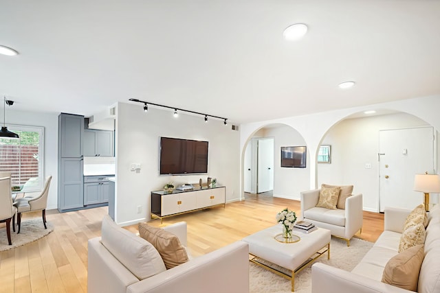 2624 State St # 1, Santa Barbara, CA 93105 - living area with arched walkways, rail lighting, light wood finished floors, and recessed lighting
