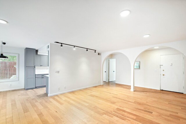 2624 State St # 1, Santa Barbara, CA 93105 - unfurnished living room with track lighting, light wood finished floors, arched walkways, and recessed lighting