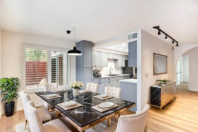 2624 State St # 1, Santa Barbara, CA 93105 - dining room with arched walkways, light wood finished floors, and track lighting