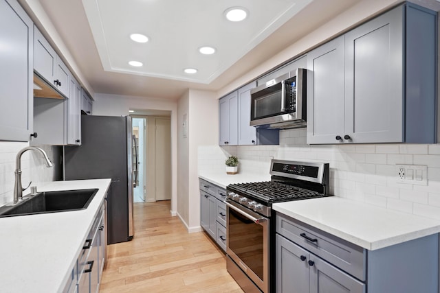 2624 State St # 1, Santa Barbara, CA 93105 - kitchen with stainless steel appliances, recessed lighting, light wood-style floors, light countertops, and gray cabinetry