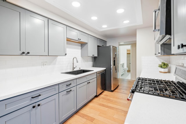 2624 State St # 1, Santa Barbara, CA 93105 - kitchen with appliances with stainless steel finishes, gray cabinetry, recessed lighting, light wood-type flooring, and light countertops