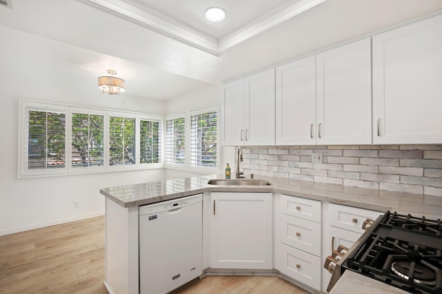 5965 Paseo Encantada, Camarillo, CA 93012 - kitchen featuring white dishwasher, a sink, stove, a peninsula, and decorative backsplash