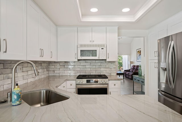 5965 Paseo Encantada, Camarillo, CA 93012 - kitchen featuring stainless steel appliances, a sink, tasteful backsplash, white cabinetry, and recessed lighting