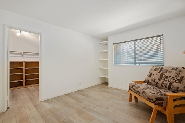 5965 Paseo Encantada, Camarillo, CA 93012 - sitting room featuring built in shelves, light wood-type flooring, and baseboards