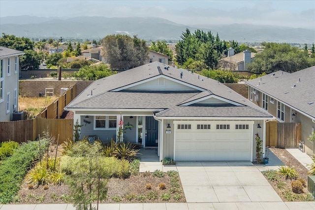 150 White Sage Ln, Lompoc, CA 93436 - view of front of home with a shingled roof, an attached garage, a mountain view, and concrete driveway