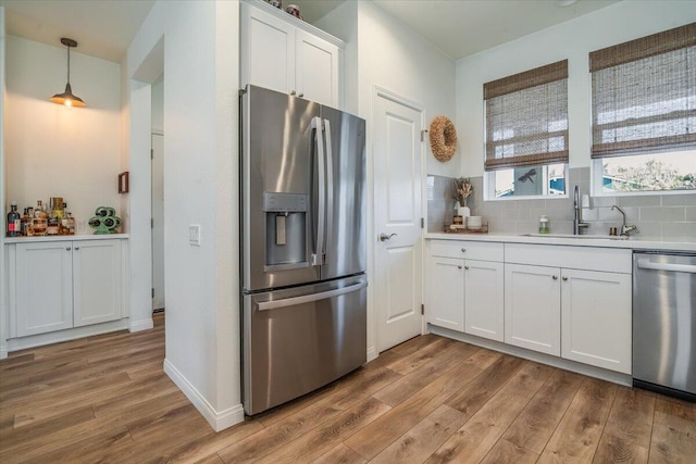 150 White Sage Ln, Lompoc, CA 93436 - kitchen with stainless steel appliances, light wood-style floors, white cabinetry, and light countertops