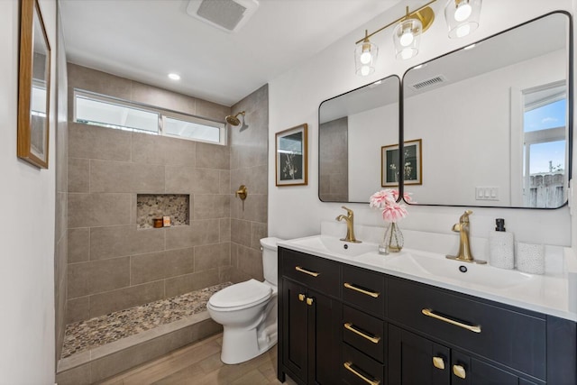 730 Meigs Rd, Santa Barbara, CA 93109 - bathroom featuring toilet, double vanity, tiled shower, and wood finished floors