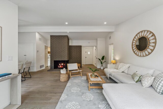 730 Meigs Rd, Santa Barbara, CA 93109 - living area featuring wood finished floors, a fireplace, lofted ceiling, recessed lighting, and baseboards
