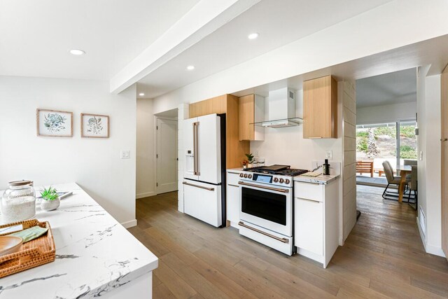 730 Meigs Rd, Santa Barbara, CA 93109 - kitchen with white appliances, wall chimney exhaust hood, light wood-style flooring, recessed lighting, and modern cabinets