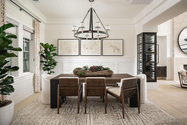 120 Polo Way, Carpinteria, CA 93013 - dining area with a chandelier, ornamental molding, a decorative wall, and wooden ceiling