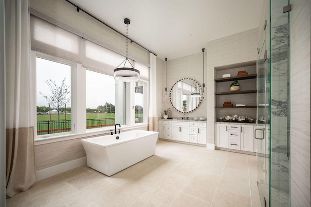 120 Polo Way, Carpinteria, CA 93013 - bathroom with vanity, a shower stall, a freestanding tub, baseboards, and tile patterned flooring