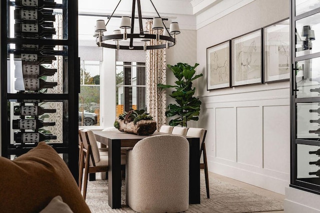 120 Polo Way, Carpinteria, CA 93013 - dining space featuring a chandelier, a decorative wall, wainscoting, and ornamental molding