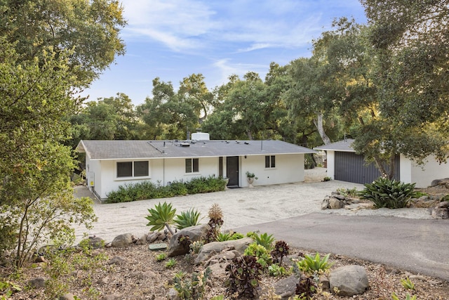1067 E Mountain Dr, Santa Barbara, CA 93108 - ranch-style house with gravel driveway, an outdoor structure, a chimney, and stucco siding