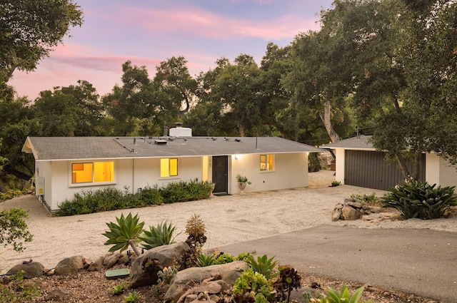 1067 E Mountain Dr, Santa Barbara, CA 93108 - view of front of property featuring a chimney, driveway, an outdoor structure, and stucco siding