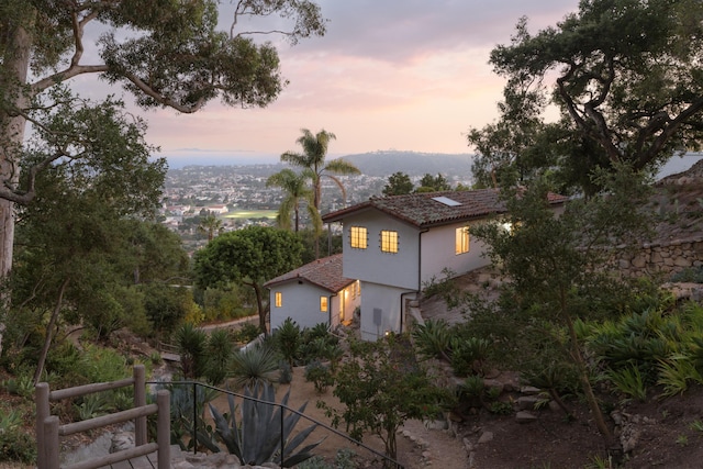 15 Loma Media Rd, Santa Barbara, CA 93103 - view of property exterior with stucco siding and roof mounted solar panels