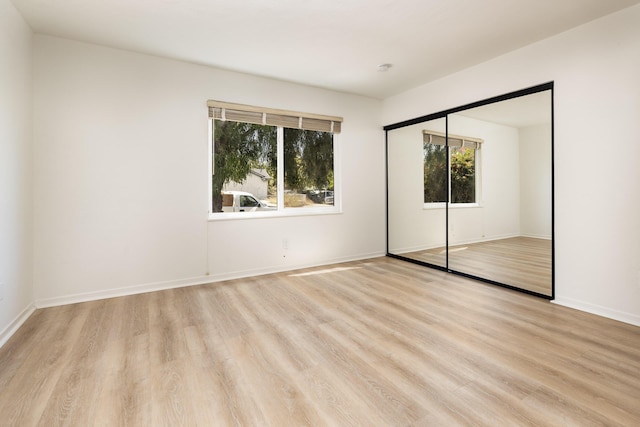 5003 Rhoads Ave, Santa Barbara, CA 93111 - unfurnished bedroom with multiple windows, light wood-type flooring, and a closet
