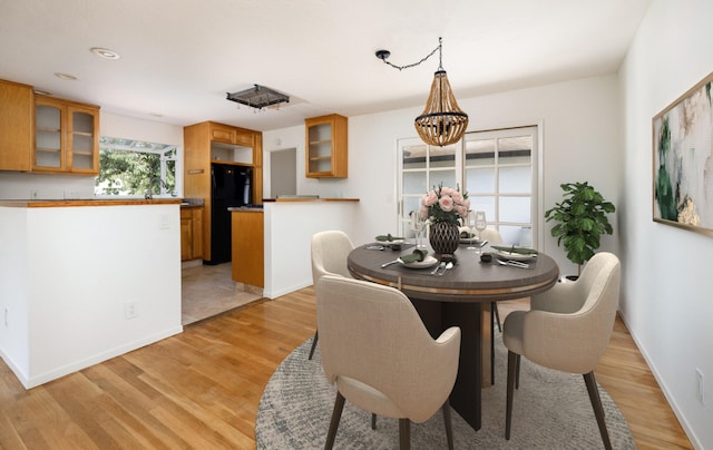 5003 Rhoads Ave, Santa Barbara, CA 93111 - dining space with light wood-style flooring and a chandelier