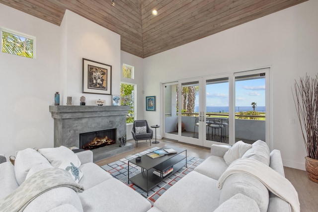 1312 Shoreline Dr, Santa Barbara, CA 93109 - living room with a towering ceiling, a water view, a high end fireplace, wood finished floors, and wood ceiling