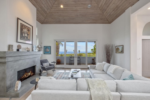 1312 Shoreline Dr, Santa Barbara, CA 93109 - living area with wooden ceiling, a high end fireplace, a water view, wood finished floors, and high vaulted ceiling