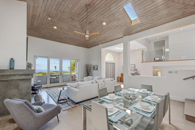1312 Shoreline Dr, Santa Barbara, CA 93109 - dining room with high vaulted ceiling, a fireplace, a skylight, a ceiling fan, and wood finished floors