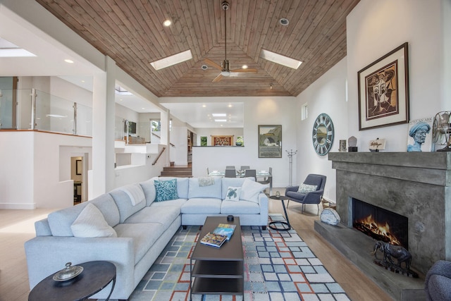 1312 Shoreline Dr, Santa Barbara, CA 93109 - living room featuring a skylight, a high end fireplace, wood ceiling, stairs, and recessed lighting