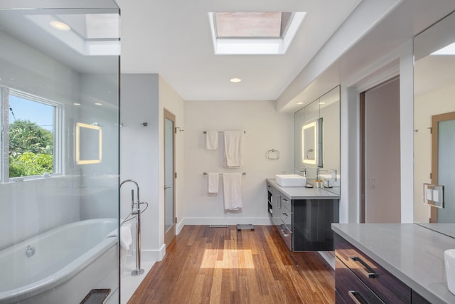 1312 Shoreline Dr, Santa Barbara, CA 93109 - bathroom with vanity, hardwood / wood-style floors, a freestanding tub, and a shower stall