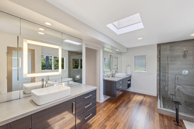 1312 Shoreline Dr, Santa Barbara, CA 93109 - bathroom with a skylight, vanity, a shower stall, wood finished floors, and recessed lighting