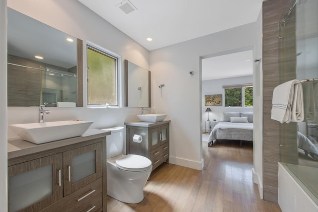 1312 Shoreline Dr, Santa Barbara, CA 93109 - full bath with wood finished floors, two vanities, a shower with shower door, ensuite bathroom, and recessed lighting