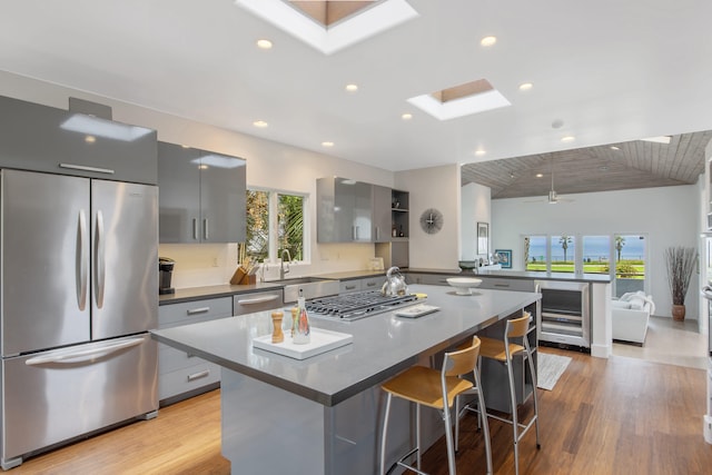 1312 Shoreline Dr, Santa Barbara, CA 93109 - kitchen featuring appliances with stainless steel finishes, a skylight, gray cabinets, beverage cooler, and recessed lighting