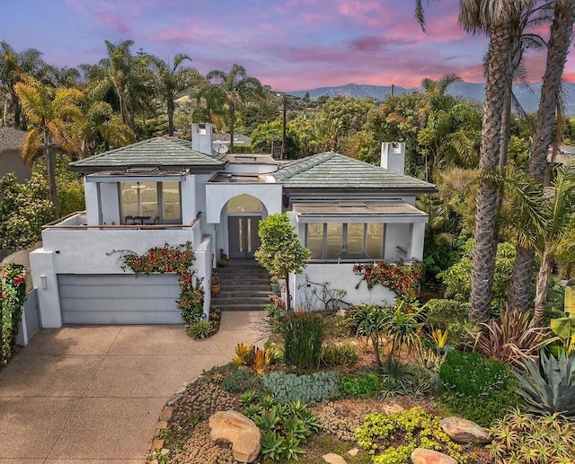 1312 Shoreline Dr, Santa Barbara, CA 93109 - mediterranean / spanish-style home with concrete driveway, a chimney, a garage, and stucco siding
