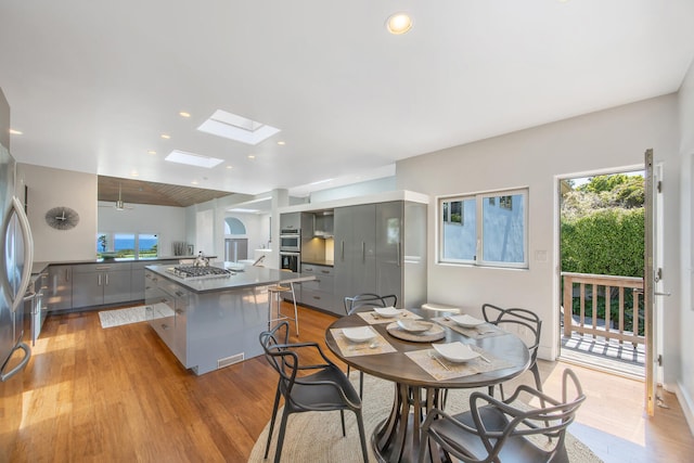 1312 Shoreline Dr, Santa Barbara, CA 93109 - dining area featuring light wood-type flooring, a skylight, and recessed lighting