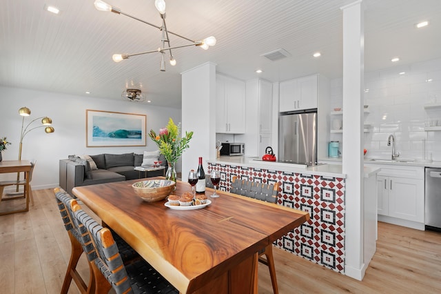 160 Ash Ave, Carpinteria, CA 93013 - dining room featuring light wood-style flooring, a chandelier, and recessed lighting