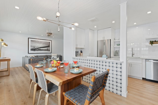 160 Ash Ave, Carpinteria, CA 93013 - dining area featuring light wood-style floors, a chandelier, and recessed lighting