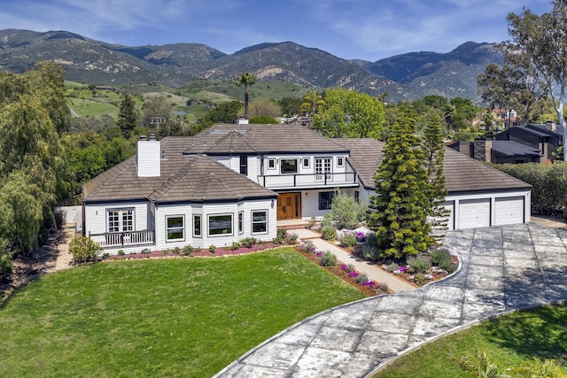 4530 Via Clarice, Santa Barbara, CA 93111 - view of front of home featuring a chimney, a mountain view, driveway, a front yard, and a balcony