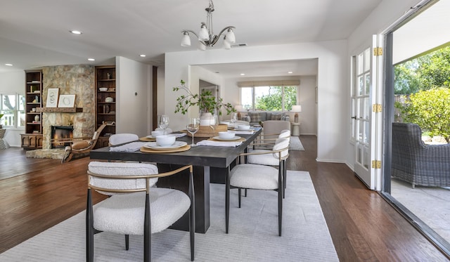 4530 Via Clarice, Santa Barbara, CA 93111 - dining room featuring built in shelves, wood finished floors, a fireplace, recessed lighting, and a chandelier