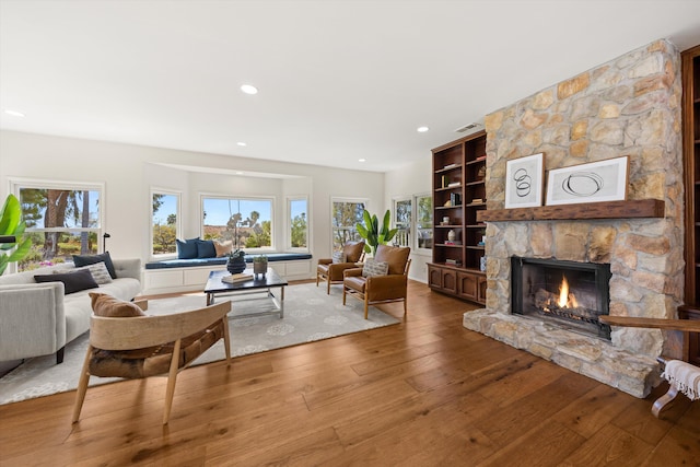 4530 Via Clarice, Santa Barbara, CA 93111 - living area featuring plenty of natural light, wood-type flooring, a stone fireplace, recessed lighting, and built in shelves