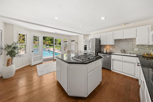 4530 Via Clarice, Santa Barbara, CA 93111 - kitchen featuring appliances with stainless steel finishes, dark countertops, dark wood-style flooring, tasteful backsplash, and recessed lighting