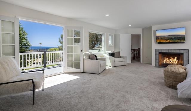4530 Via Clarice, Santa Barbara, CA 93111 - living room featuring carpet flooring, a tile fireplace, a water view, and recessed lighting