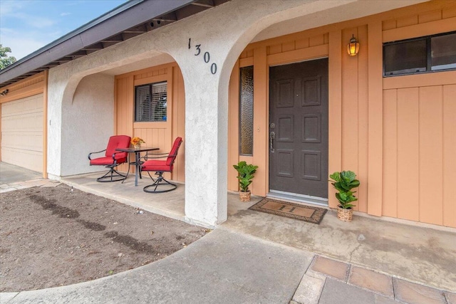 1300 E Airport Ave, Lompoc, CA 93436 - property entrance with covered porch, an attached garage, and stucco siding