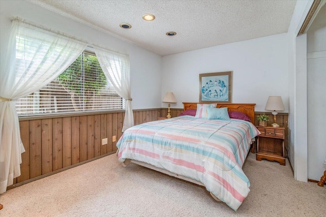 1300 E Airport Ave, Lompoc, CA 93436 - bedroom featuring carpet, wooden walls, a wainscoted wall, and a textured ceiling
