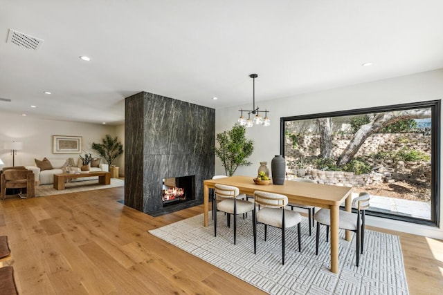 1412 Crestline Dr, Santa Barbara, CA 93105 - dining area featuring recessed lighting, a multi sided fireplace, light wood-style floors, and a chandelier