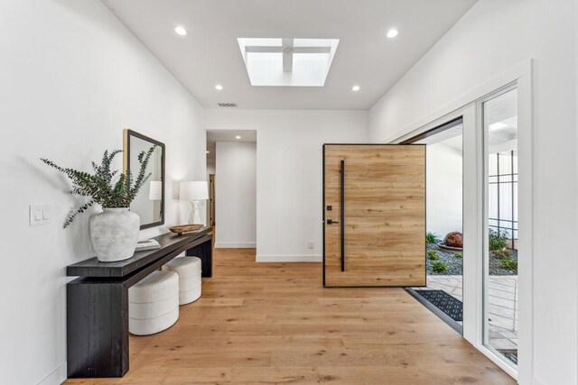 1412 Crestline Dr, Santa Barbara, CA 93105 - foyer entrance with light wood finished floors, a skylight, and recessed lighting