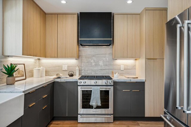 1412 Crestline Dr, Santa Barbara, CA 93105 - kitchen featuring stainless steel appliances, ventilation hood, modern cabinets, light brown cabinetry, and recessed lighting