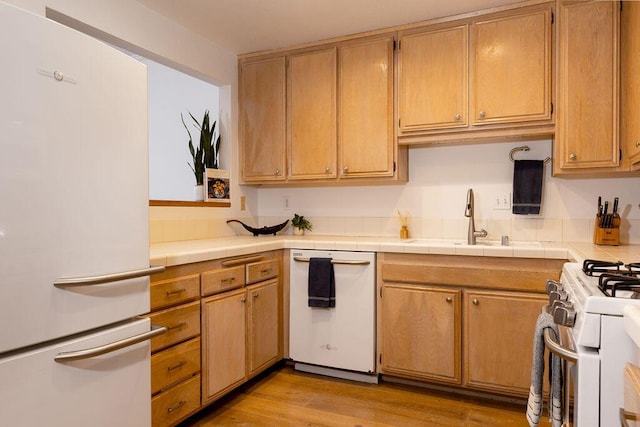 4515 Carpinteria Ave Unit G, Carpinteria, CA 93013 - kitchen featuring white appliances, light wood-style flooring, and tile counters